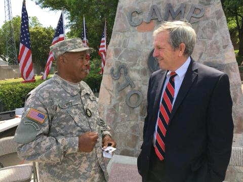 Military soldier saluting American flag